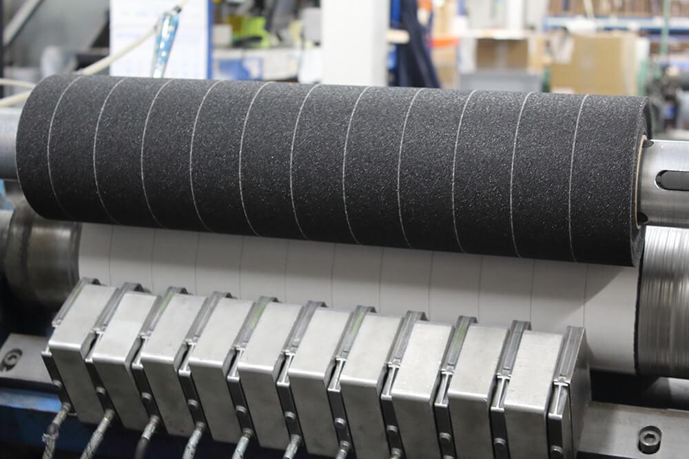 Black Anti-Slip Material being Crush Cut into Rolls of Non Slip Tape