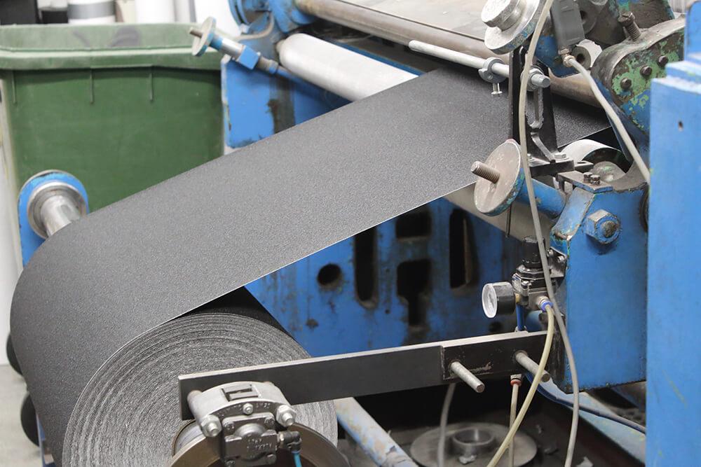 Black Anti-Slip Material being Cut on a Crush Cutter into Rolls of Non Slip Tape 2