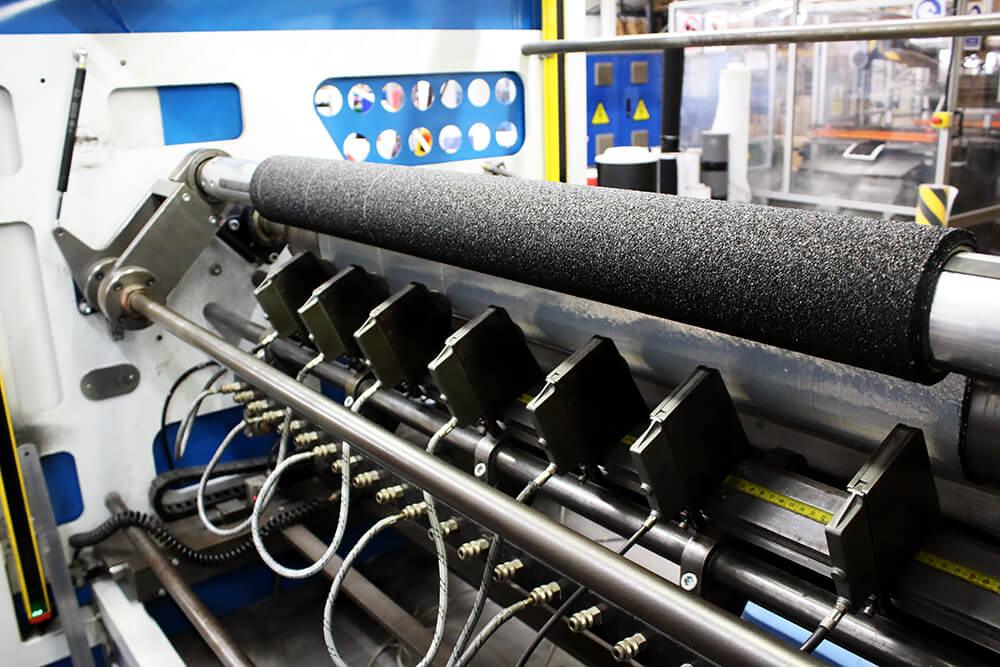 Black Anti-Slip Material being Cut on a Crush Cutter into Rolls of Non Slip Tape 3