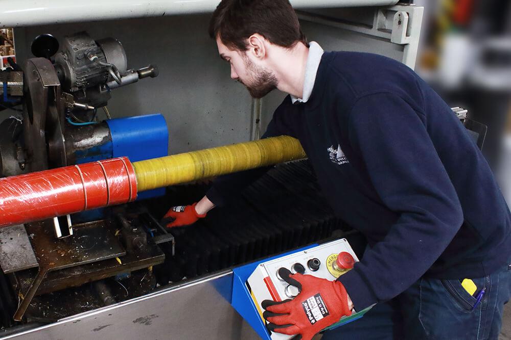 Cevenini Log Tape Slitter in Action Cutting Red Anti Slip Tape
