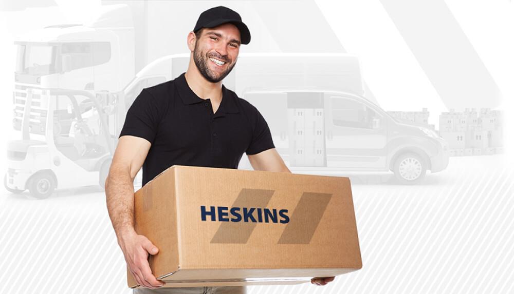 Delivery Man Holding Heskins Branded Cardboard Box