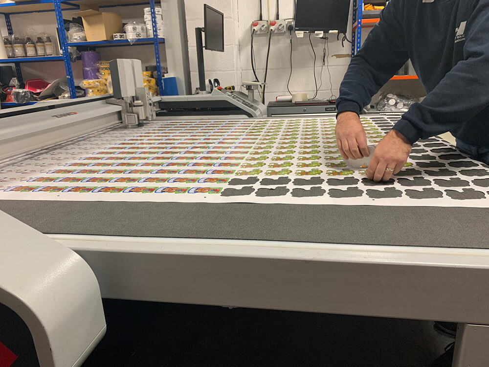 Small Custom Printed Stickers Being Cut on Digital Cutting Machine 1